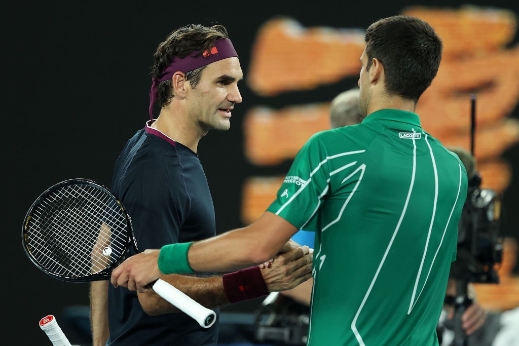 Serbia's Novak Djokovic shakes hands with Switzerland's Roger Federer after their men's singles semi-final at the 2020 Australian Open