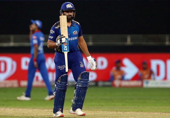 Rohit Sharma celebrates after completing his half-century