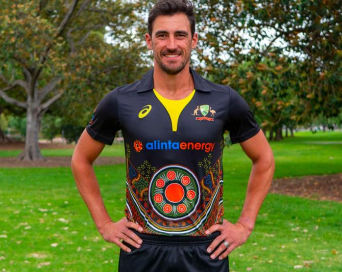 Australia pacer Mitchell Starc models the new jersey that will be worn during the T20Is against India