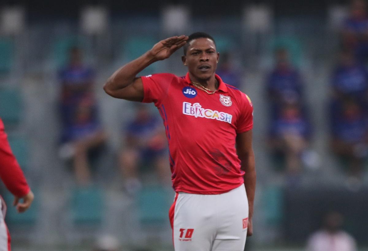 Kings XI Punjab pacer Sheldon Cottrell celebrates after crashing into the stumps of Mumbai Indians opener Quinton de Kock.