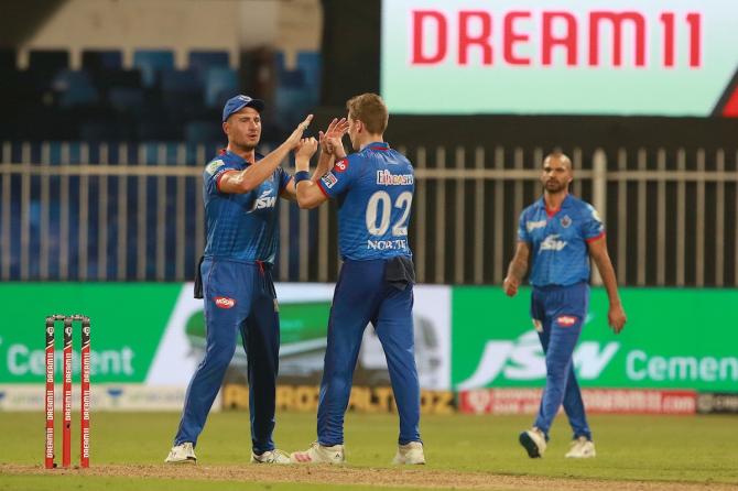 Anrich Nortje celebrates with Marcus Stoinis after dismissing Eoin Morgan.