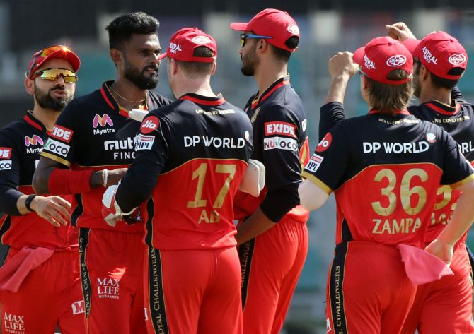 Royal Challengers Bangalore's players celebrate after Isara Udana claims the wicket of Rajasthan Royals opener Steve Smith