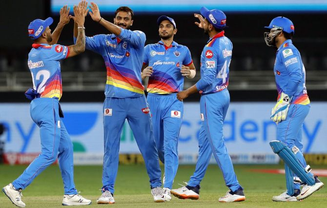 Axar Patel, second from left, celebrates with teammates after taking the wicket of Aaron Finch. 