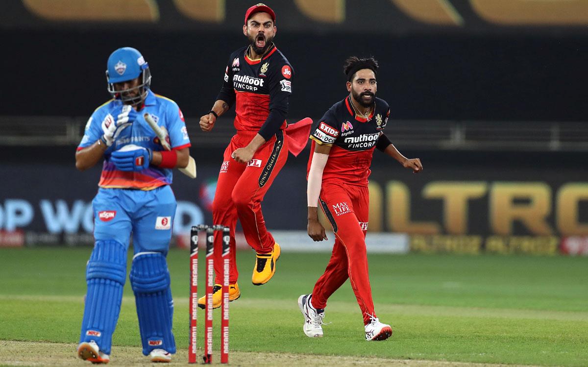 Mohammed Siraj celebrates with captain Virat Kohli after taking the wicket of Delhi Capitals opener Prithvi Shaw/