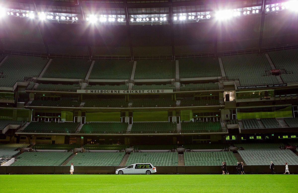 A hearse carrying Dean Jones' handmade Indian coffin was adorned with the Australian flag and a floral 324 arrangement showcasing Deano's Australian Test cap number 