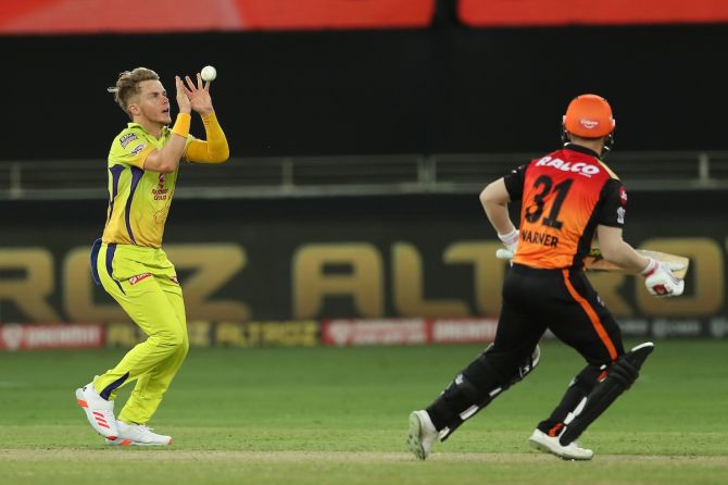 Sam Curran takes the catch of David Warner off his own bowling.