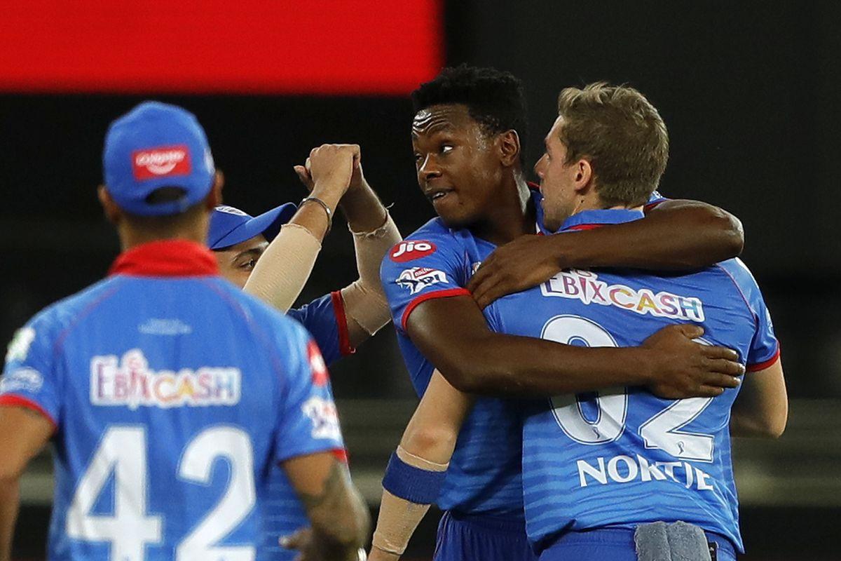 Delhi Capitals' Kagiso Rabada and Anrich Nortje celebrate the wicket of Robin Uthappa