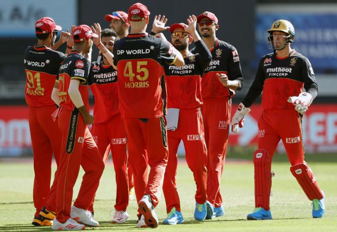 Royal Challengers Bangalore's players celebrate after Yuzvendra Chahal gets the wicket of Sanju Samson