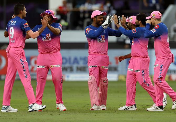 Rajasthan Royals' players celebrate the wicket of RCB captain Virat Kohli