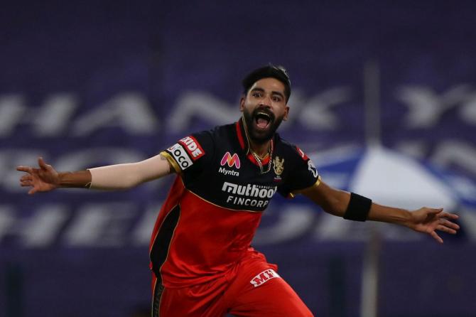 Royal Challengers Bangalore's Mohammed Siraj celebrates dismissing Kolkata Knight Riders' opener Rahul Tripathi