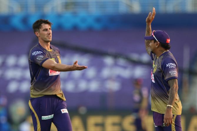 Pat Cummins celebrates with Sunil Narine after dismissing Kagiso Rabada.