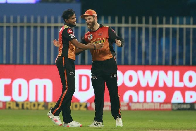 T Natarajan celebrates with Kane Williamson after taking the wicket of Washington Sundar