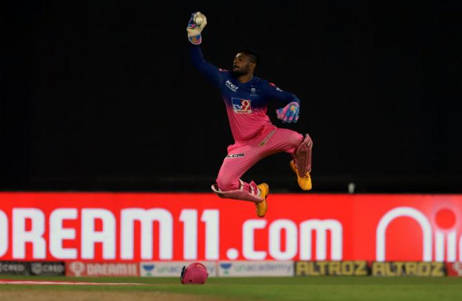 Wicketkeeper Sanju Samson takes the catch to dismiss Kedar Jadhav off the bowling of Tom Curran