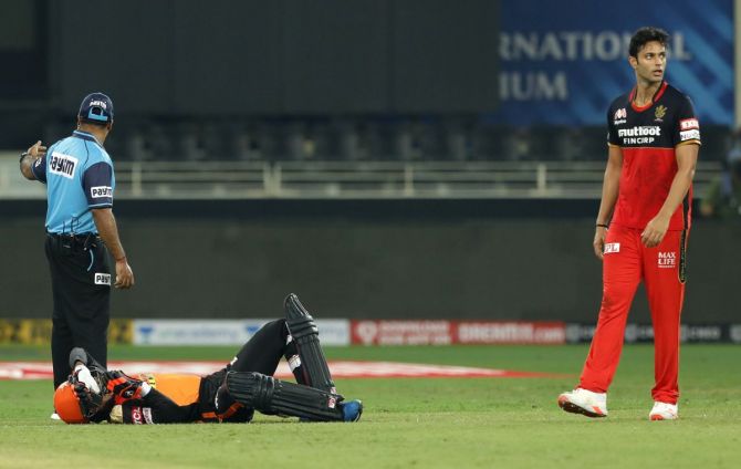 Sunrisers Hyderabad's Rashid Khan grimaces in pain after colliding with teammate Abhishek Sharma while taking two runs
