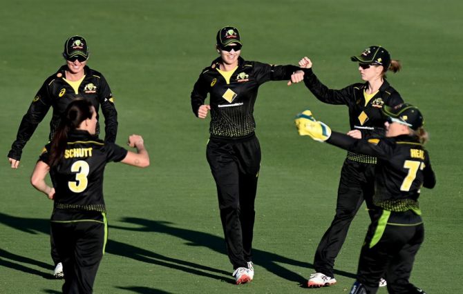 Australia's Meg Lanning celebrates with teammates after dismissing New Zealand's Katey Martin during game one of the T20 Women's International series between Australia and New Zealand at Allan Border Field in Brisbane on Saturday 