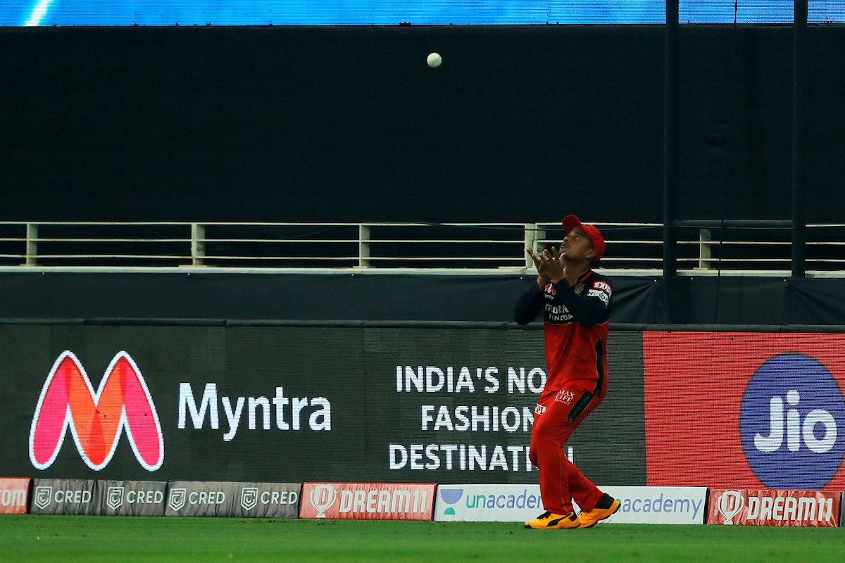 Pawan Negi takes a well-judged catch to dismiss Rohit Sharma.