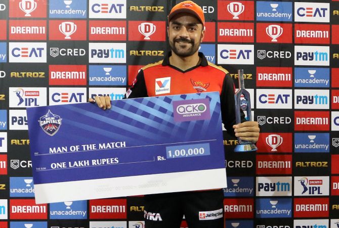Rashid Khan with the man of the match award after his fine bowling against Delhi Capitals in the IPL match in Abu Dhabi on Tuesday.