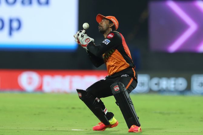 Sunrisers Hyderabad wicketkeeper Wriddhiman Saha takes the catch to dismiss Rahul Tripathi.