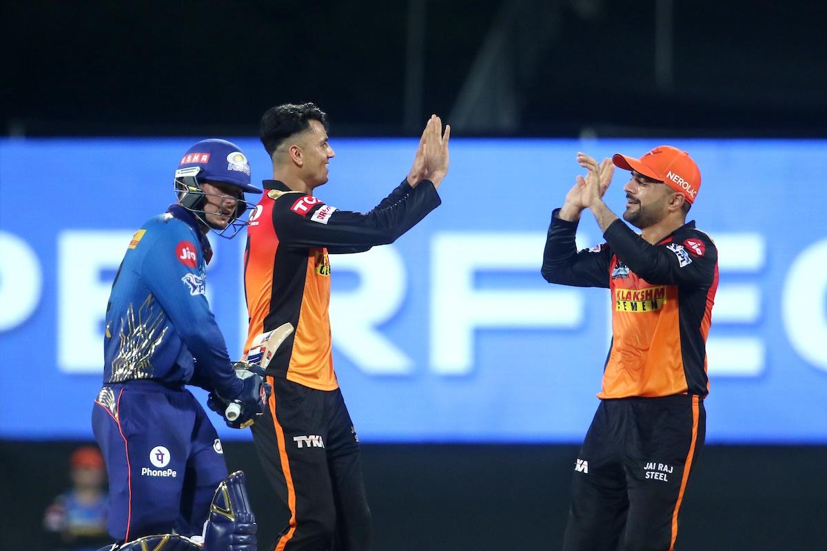 Mujeeb Ur Rahman and Rashid Khan celebrate the wicket of Quinton de Kock