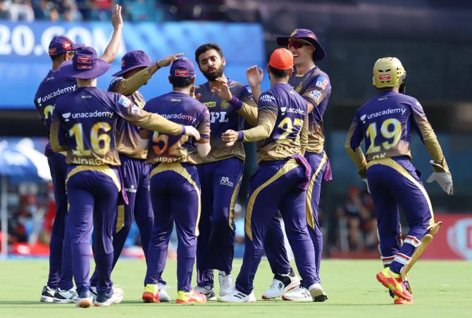 Kolkata Knight Riders players celebrate the dismissal of Virat Kohli