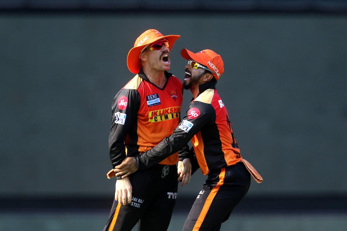 David Warner  celebrates with Kedar Jadhav after running out Nicholas Pooran