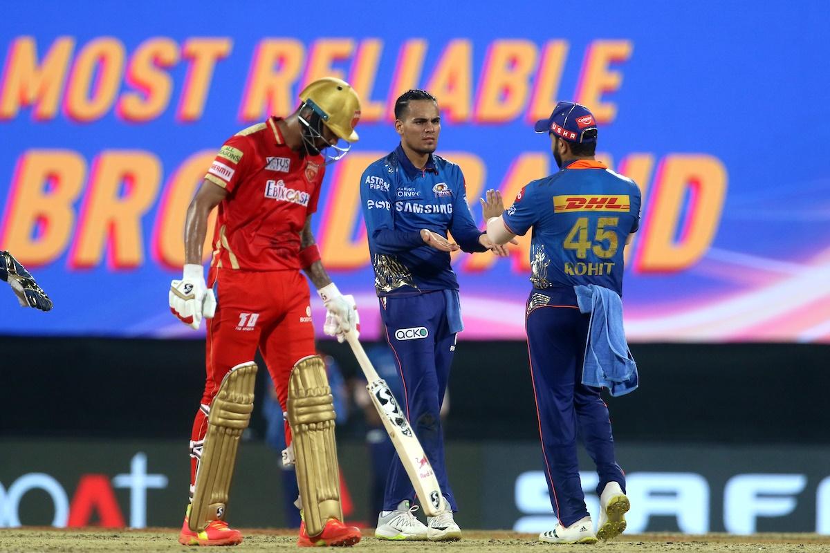 Rahul Chahar is congratulated by skipper Rohit Sharma after dismissing Mayank Agarwal