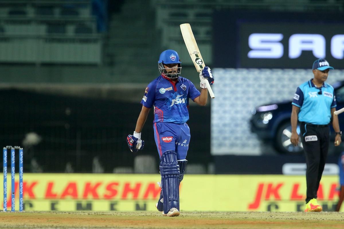 Prithvi Shaw raises his bat after scoring 50.