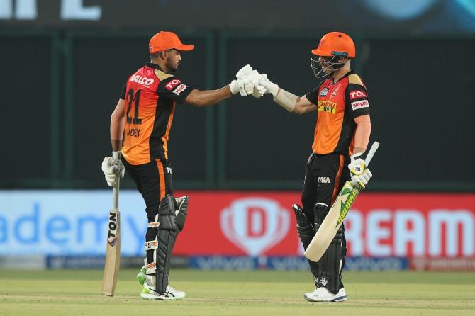 Manish Pandey and David Warner celebrate after bringing up a 100-run stand for the second wicket.