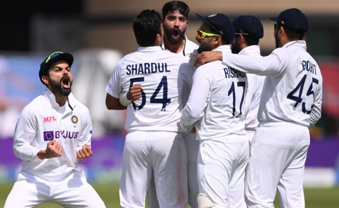 ndia's captain Virat Kohli reacts after winning the review against Zak Crawley, who was caught behind by Rishabh Pant off Mohammed Siraj's bowling