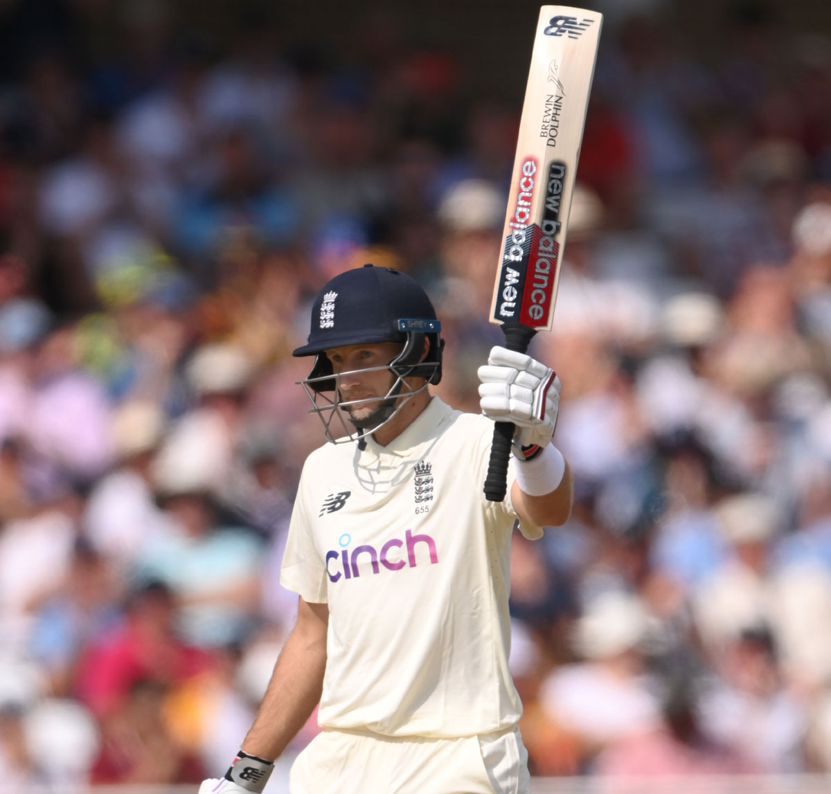 Joe Root waves to the stands after completing 50.