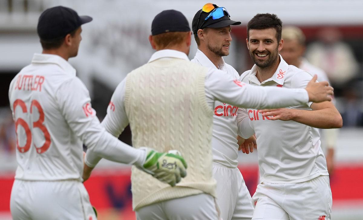 Mark Wood celebrates with teammates after dismissing Rishabh Pant.