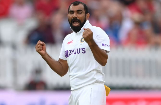 Mohammed Shami celebrates after taking the wicket of Rory Burns following a review.