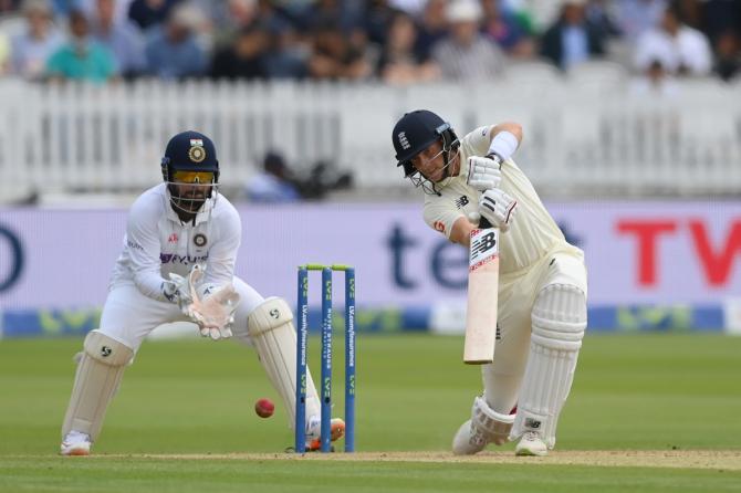 India's wicketkeeper Rishabh Pant watches as Joe Root plays the ball down the track. 