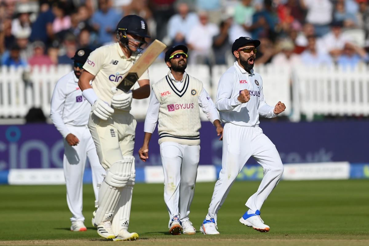 Virat Kohli celebrates the wicket of Sam Curran.