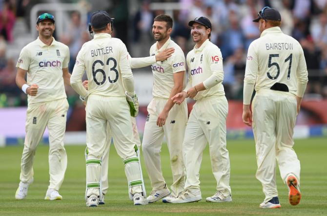 England pacer Mark Wood celebrates with teammates after dismissing Cheteshwar Pujara.