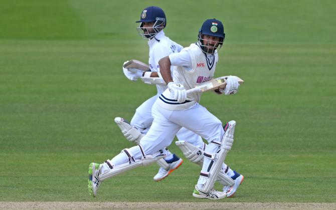 Cheteshwar Pujara, right, and Ajinkya Rahane steal a single.