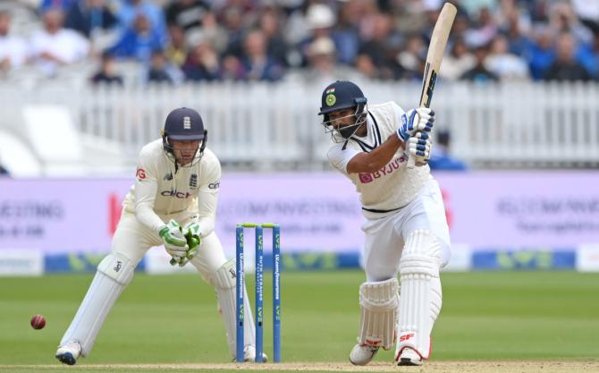 Jos Buttler watches as Mohammed Shami bats.