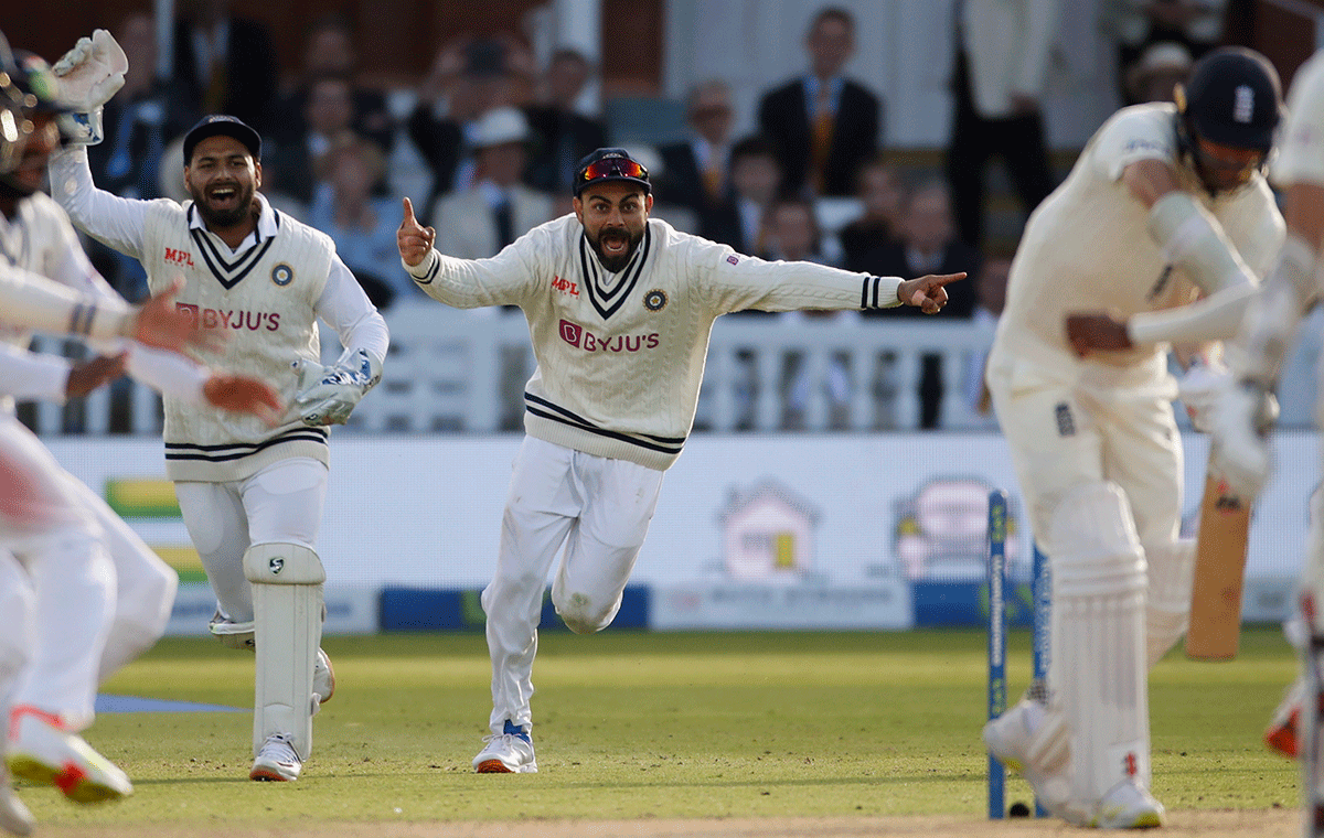 India's captain Virat Kohli celebrates winning the second Test with teammates after Mohammed Siraj dismisses England's James Anderson to win the 2nd Test at Lord's  in London on Monday, August 16. 