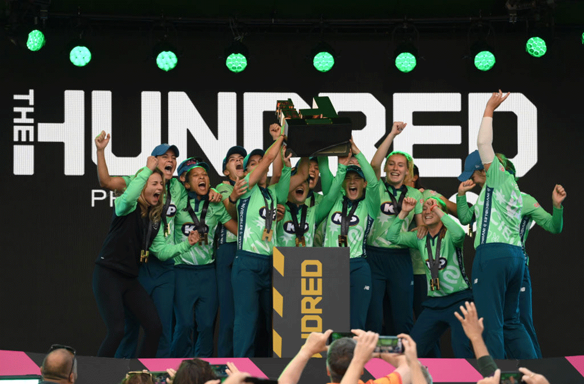 The Oval Invincibles Women celebrate with the trophy after winning The Hundred final against Southern Brave Women at Lord's Cricket Ground in London on Saturday