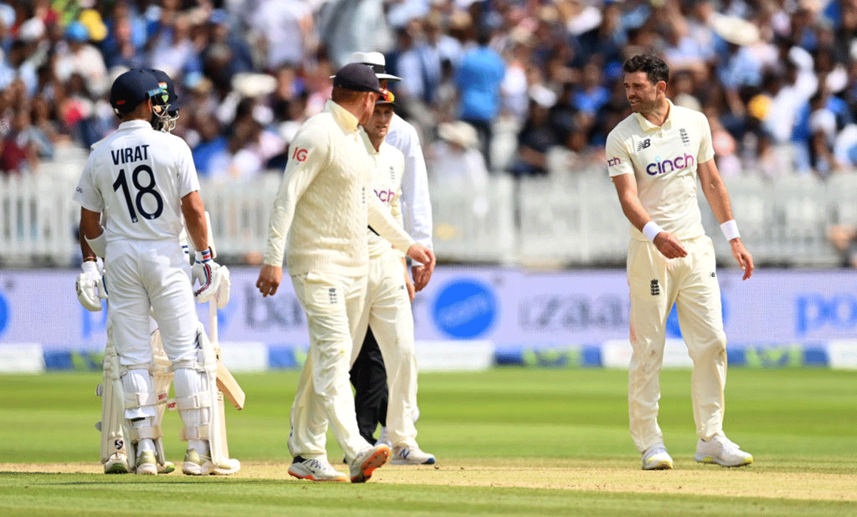 Joe Root intervenes as England bowler James Anderson and India captain Virat Kohli exchange verbal volleys. 