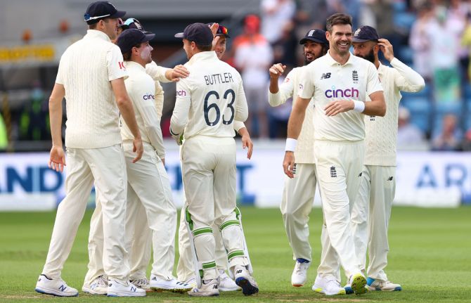 James Anderson celebrates with his England teammates after capturing the wicket of K L Rahul.