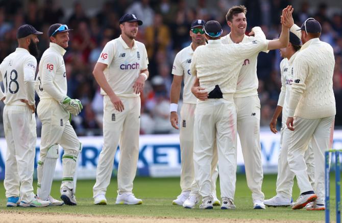 Craig Overton celebrates taking the wicket of Rohit Sharma.