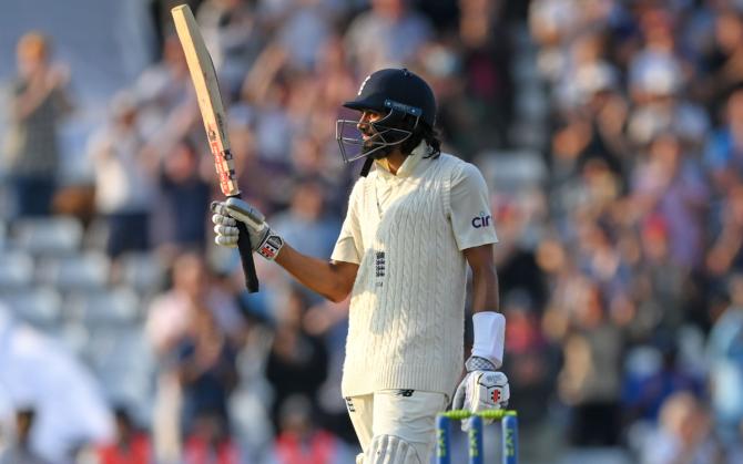 Haseeb Hameed waves to the crowd after posting 50