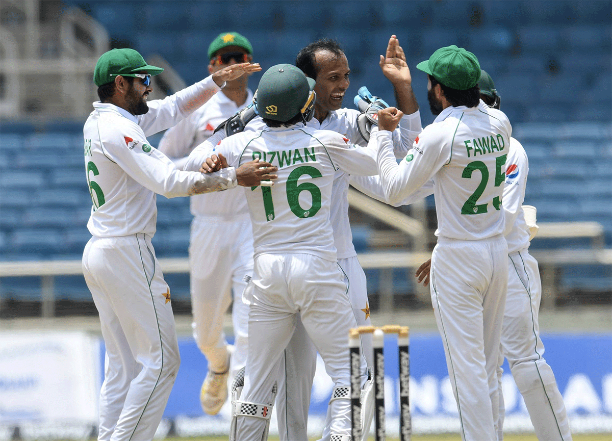 Nauman Ali celebrates with teammates after dismissing Windies captain Kraigg Brathwaite