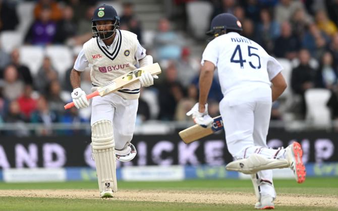 Cheteshwar Pujara and Rohit Sharma run between the wickets during their unbroken 78-run partnership before the tea break. 