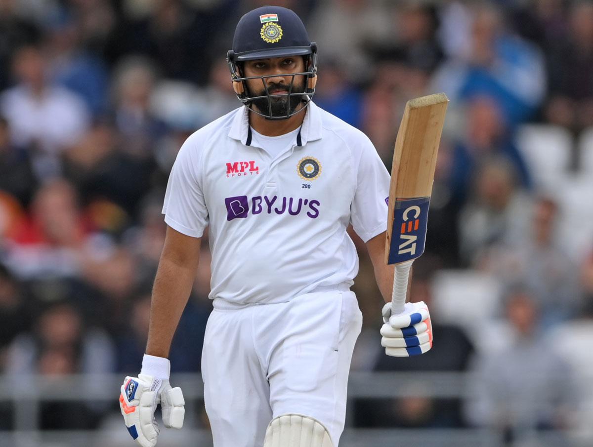 India opener Rohit Sharma waves to the dressing room to celebrate scoring 50 in the second innings