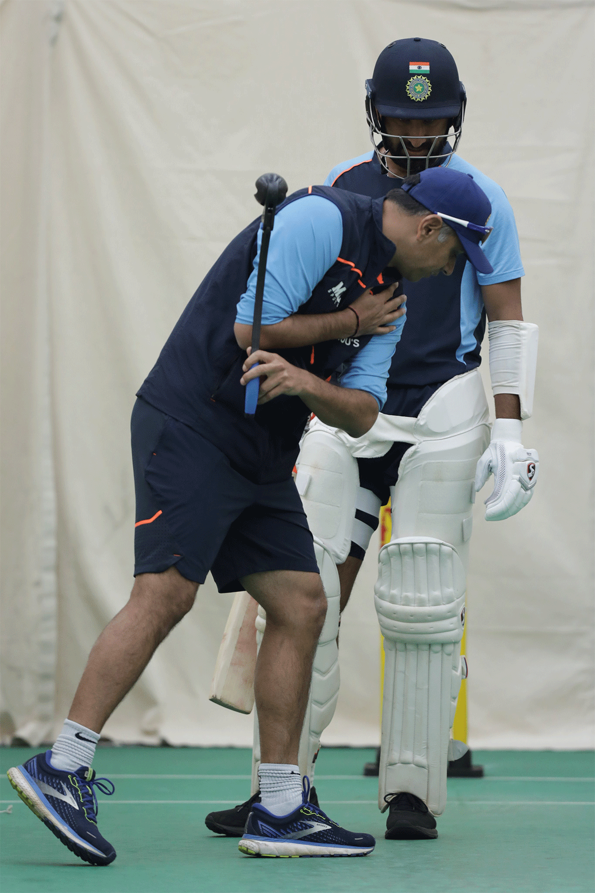 Cheteshwar Pujara watches keenly as Rahul Dravid coaches him in the nets