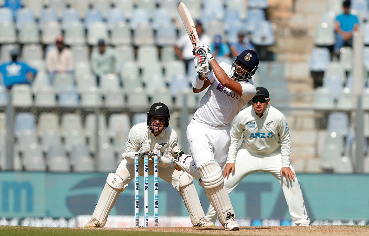 Axar Patel hits over the boundary.