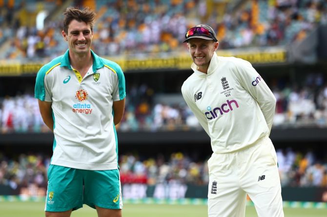 Australia captain Pat Cummins and England captain Joe Root at the post-match presentation for the first Ashes Test, at The Gabba in Brisbane, on Saturday. 