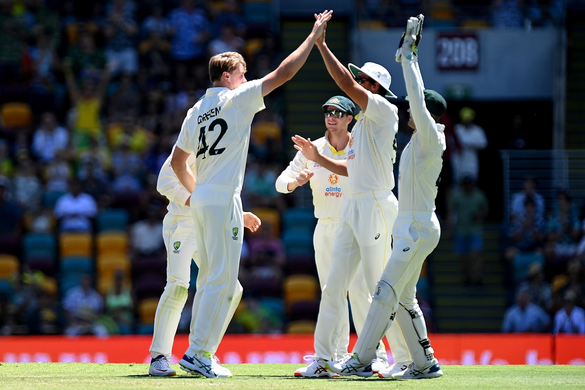 Cameron Green celebrates with teammates after dismissing Joe Root on Day 4 of the 1st Ashes Test at the Gabba in Brisbane on Saturday